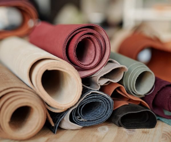 collection-of-rolled-suede-and-leather-of-various-colors-lying-on-wooden-table.jpg